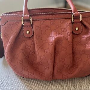 A Gucci handbag with crossbody strap.